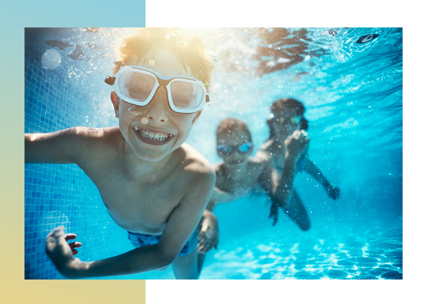 underwater picture of smiling kid in pool